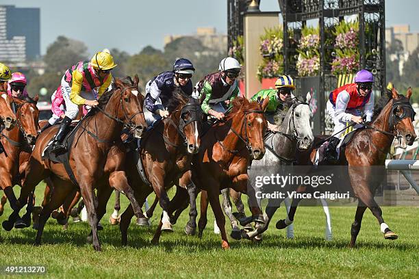 Dwayne Dunn riding Let's Make Adeal races into the first turn before winning Race 6, the Bart Cummings during Turnbull Stakes Day at Flemington...