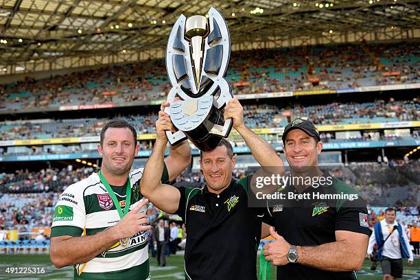 Chris Walker, Ben Walker, Shane Walker of the Jets hold aloft the winners trophy after the 2015 State Championship Grand Final match between Ipswich...