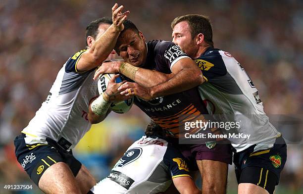 Justin Hodges of the Broncos is tackled by the Cowboys defence during the 2015 NRL Grand Final match between the Brisbane Broncos and the North...