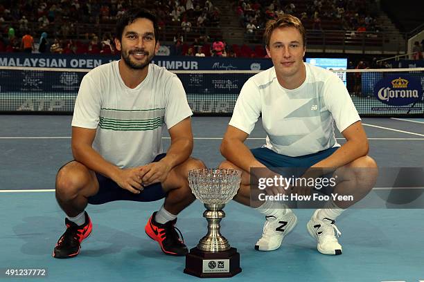 Treat Huey of Philippines and Henri Kontinen of Finland poses with their trophy after defeating Raven Klaasen of RSA and Rajeev Ram of USA in the...