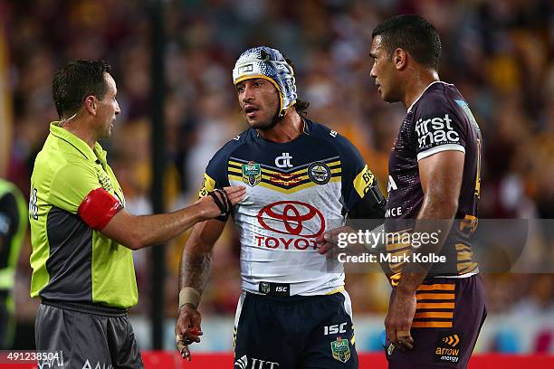 Referee Gerard Sutton talks with Justin Hodges of the Broncos and Johnathan Thurston of the Cowboys during the 2015 NRL Grand Final match between the...