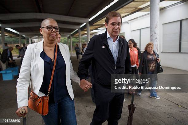 Portuguese Prime Minister and Social Democratic Party's leader Pedro Passos Coelho leaves with his wife Laura Ferreira after casting his vote during...