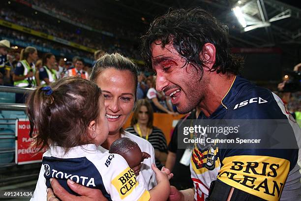 Johnathan Thurston of the Cowboys celebrates victory with his wife Samantha Lynch and daughter after the 2015 NRL Grand Final match between the...