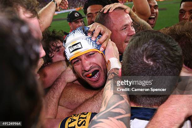 Johnathan Thurston of the Cowboys celebrates with team mates after winning the 2015 NRL Grand Final match between the Brisbane Broncos and the North...