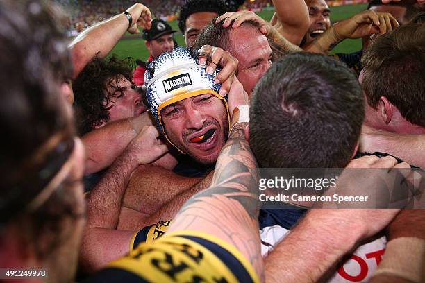 Johnathan Thurston of the Cowboys celebrates with team mates after winning the 2015 NRL Grand Final match between the Brisbane Broncos and the North...