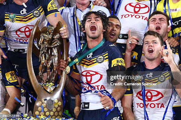 Johnathan Thurston of the Cowboys celebrates with the premiership trophy after winning the 2015 NRL Grand Final match between the Brisbane Broncos...