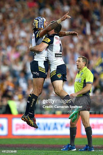Johnathan Thurston of the Cowboys celebrates with Lachlan Coote of the Cowboys after kicking a field goal in extra-time to win the 2015 NRL Grand...