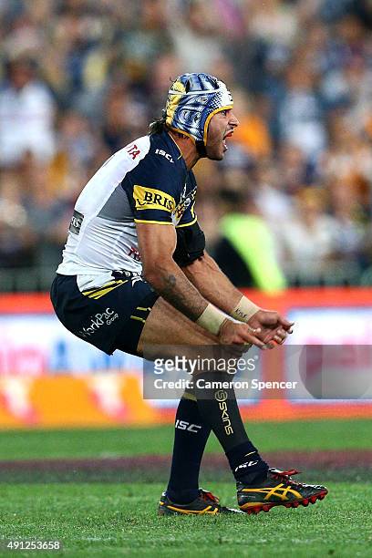 Johnathan Thurston of the Cowboys kicks a field goal in extra-time to win the 2015 NRL Grand Final match between the Brisbane Broncos and the North...