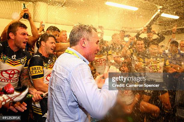 Cowboys coach Paul Green is sprayed by his players with champagne after winning the 2015 NRL Grand Final match between the Brisbane Broncos and the...