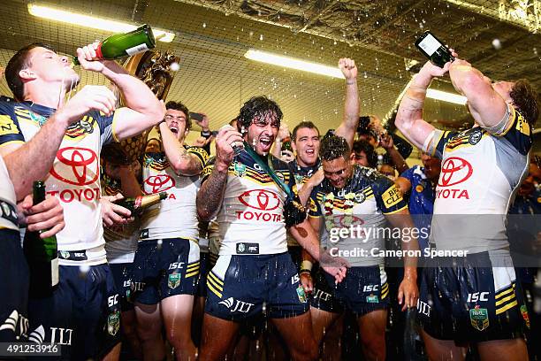 Cowboys captain Johnathan Thurston and team mates sing their team song in the Cowboys changeroom after winning the 2015 NRL Grand Final match between...