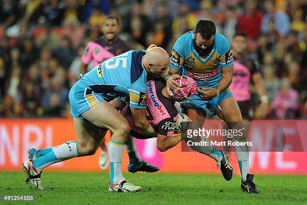 Todd Lowrie of the Broncos is tackled during the round 10 NRL match between the Brisbane Broncos and the Gold Coast Titans at Suncorp Stadium on May...