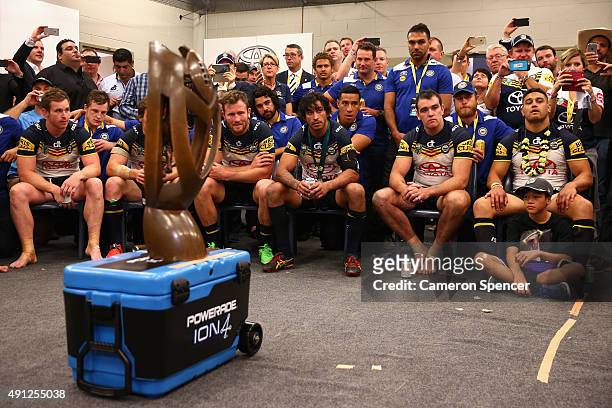 Cowboys players listen to coach Paul Green talk in the Cowboys changeroom after winning the 2015 NRL Grand Final match between the Brisbane Broncos...