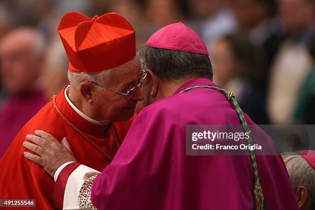 Cardinal chats with a bishop during a mass for the opening of the Synod on the themes of family held by Pope Francis at St. Peter's Basilica on...