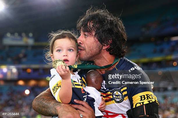 Cowboys captain Johnathan Thurston takes a moment in the centre of the field with his daughter Frankie Thurston after winning the 2015 NRL Grand...
