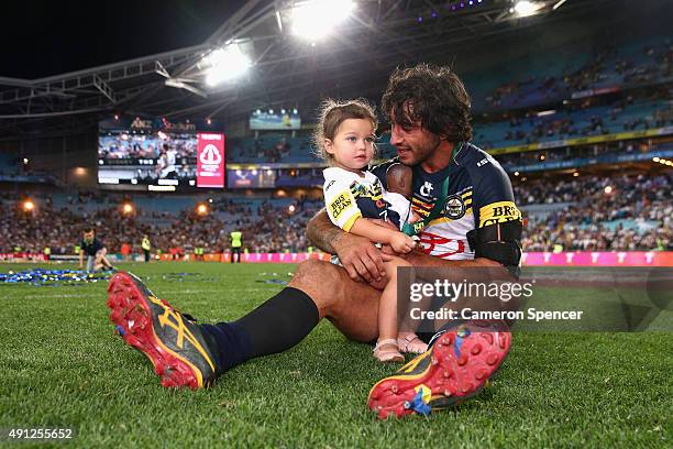 Cowboys captain Johnathan Thurston takes a moment in the centre of the field with his daughter Frankie Thurston after winning the 2015 NRL Grand...
