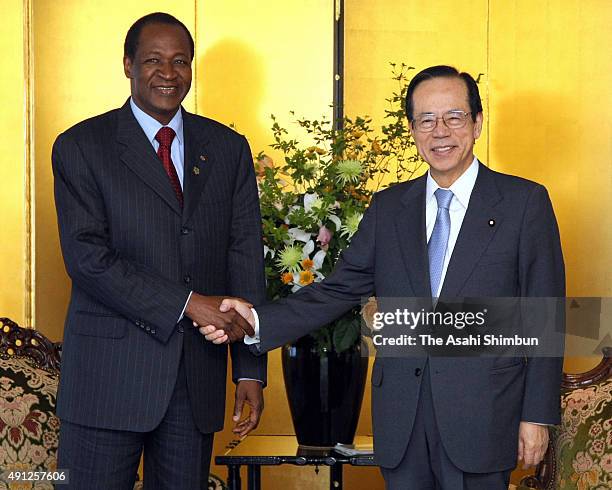 Burkina Faso President Blaise Compaore and Japanese Prime Minister Yasuo Fukuda shake hands during their meeting ahead of the Tokyo International...