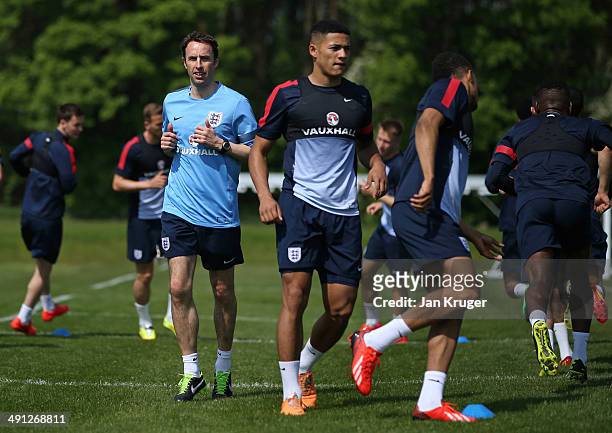 England U21 Manager Gareth Southgate warms up with the team during the England U21 training session at St Georges Park on May 16, 2014 in...