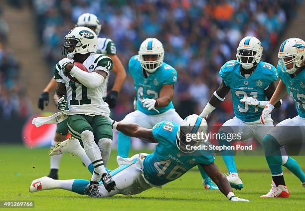 Jeremy Kerley of the New York Jets beats the tackle of Neville Hewitt of the Miami Dolphins during the game at Wembley Stadium on October 4, 2015 in...