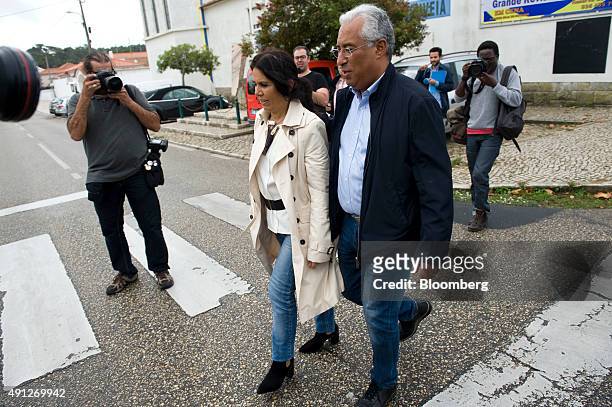 Antonio Costa, leader of the Socialist party , right, with his wife Fernanda Tadeu, leaves a polling station after casting his ballot during the...