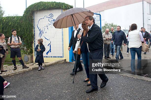 Pedro Passos Coelho, Portugals Prime Minister and leader of the Social Democratic Party , right, with his wife Laura Ferreira, leave a polling...