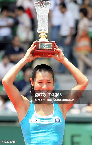 Kimiko Date-Krumm celebrates with the trophy after winning the Ladies' Singles final against Shiho Akita during the day six of the Tokyo Ariake...