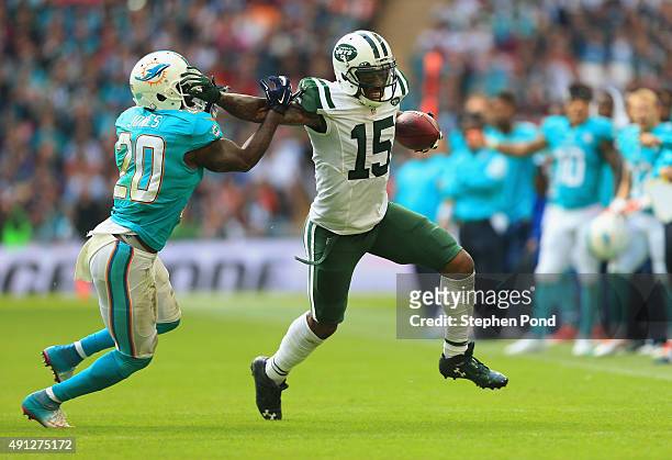 Brandon Marshall of the New York Jets holds off Reshad Jones of the Miami Dolphins during the game at Wembley Stadium on October 4, 2015 in London,...