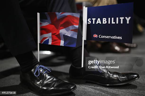 Delegate wears party flags in his shoes as British Defence Secretary Michael Fallon speaks during day one of the Conservative Party Conference on...