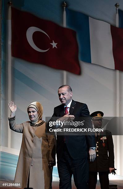 Turkish President Recep Tayyip Erdogan and his wife Emine wave to supporters during a political rally in Strasbourg, eastern France, on October 4,...