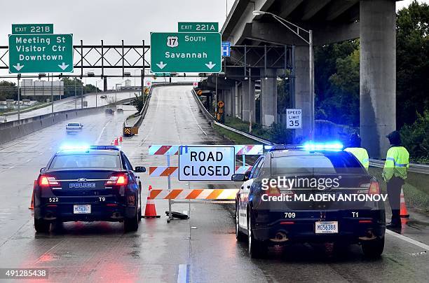 Police block the entrance of highway 17 due to the floods in Charleston, South Carolina on October 4, 2015. Relentless rain left large areas of the...
