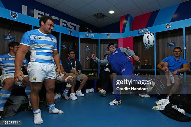 In this handout photograph provided by World Rugby via Getty Images, Diego Maradona juggles a rugby ball watched by Agustin Creevy as he visits the...