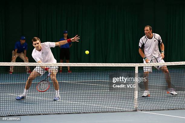 Colin Fleming of Britain and Jonathan Erlich of Israel return a shot against Chris Guccione of Australia and Andre Sa of Brazil during the men's...