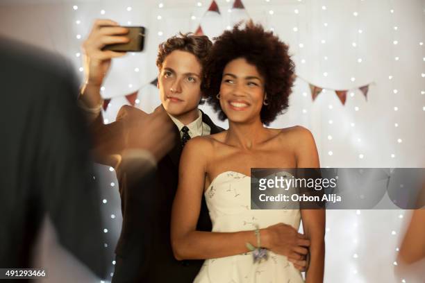 couple taking a selfie at prom party - prom stockfoto's en -beelden
