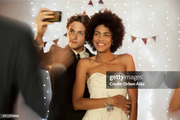 couple taking a selfie at prom party - prom dress stock pictures, royalty-free photos & images