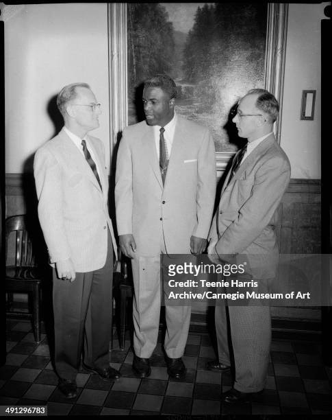Bernard McCormick, Brooklyn Dodgers baseball player Jackie Robinson, and CF Kortner, standing in front of landscape painting in Schenley High School,...