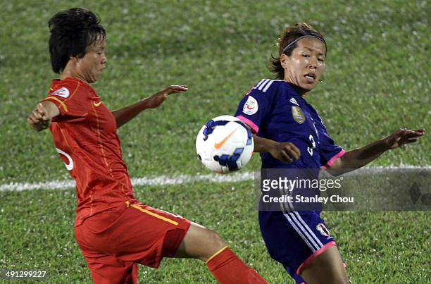 Azusa Iwashimizu of Japan challenges Nguyen Thi Xuyen of Vietnam during the AFC Women's Asian Cup Group A match between Japan and Vietnam at Thong...