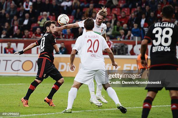 Jan-Ingwer Callsen-Bracker of FC Augsburg plays the ball with the hand during the Bundesliga match between Bayer Leverkusen and FC Augsburg at...