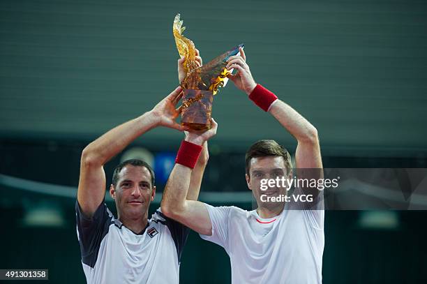 Colin Fleming of Britain and Jonathan Erlich of Israel pose with their trophy after beating Chris Guccione of Australia and Andre Sa of Brazil during...
