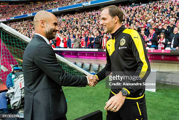 Head coach Thomas Tuchel of Borussia Dortmund and Bayern's head coach Pep Guardiola prior to the Bundesliga match between FC Bayern Muenchen and...
