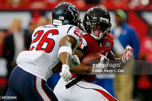 Devonta Freeman of the Atlanta Falcons runs for a touchdown past Rahim Moore of the Houston Texans in the first half at the Georgia Dome on October...