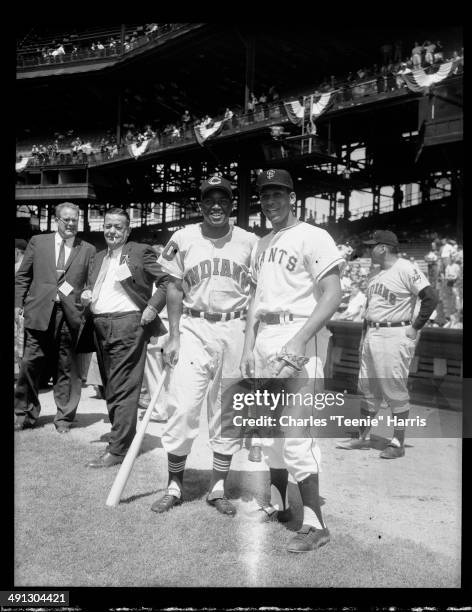 Cleveland Indians baseball player no 10 Vic Power with bat, posing with San Francisco Giants player Orlando Cepeda with glove, with reporters in...