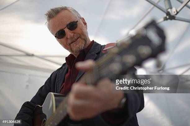 Billy Bragg waits to perform before the start of an anti-austerity protest during the first day of the Conservative Party Autumn Conference 2015 on...