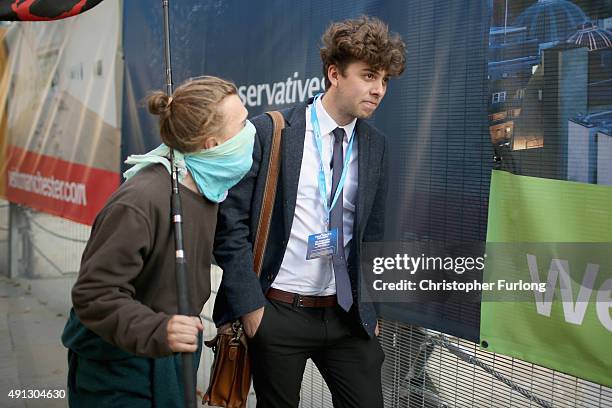 An anarchist protester confronts a delegate attending the first day of the Conservative Party Autumn Conference 2015 on October 4, 2015 in...