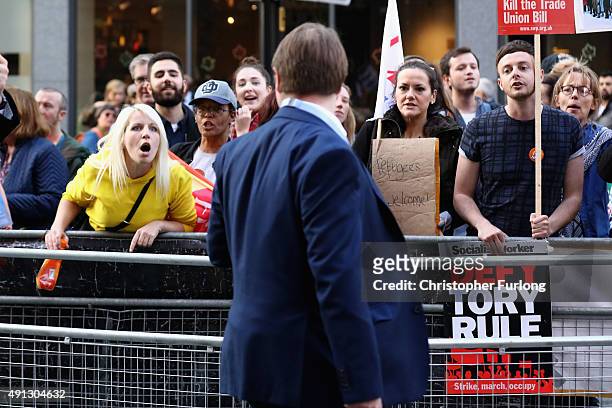 An protester confronts a delegate attending the first day of the Conservative Party Autumn Conference 2015 on October 4, 2015 in Manchester, England....