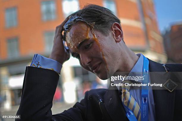 Young Tory delegate is hit by an egg as he arrives for the first day of the Conservative Party Autumn Conference 2015 on October 4, 2015 in...