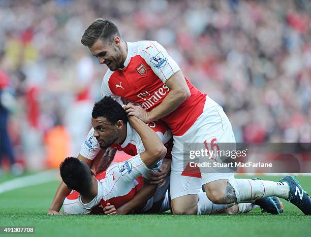 Alexis Sanchez celenrayes scoring the 3rd Arsenal goal with Francis Coquelin and Aaron Ramsey during the Barclays Premier League match between...