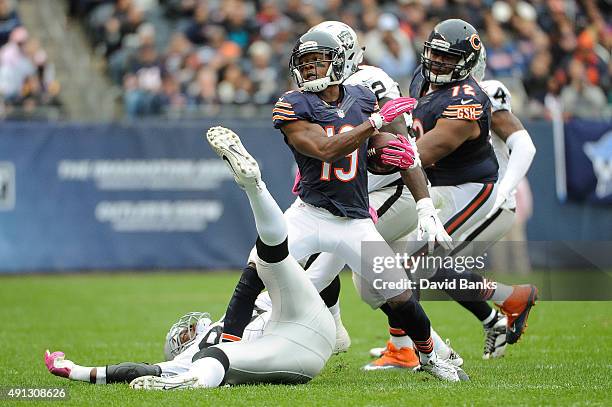 Eddie Royal of the Chicago Bears steps over Aldon Smith of the Oakland Raiders in the first quarter at Soldier Field on October 4, 2015 in Chicago,...