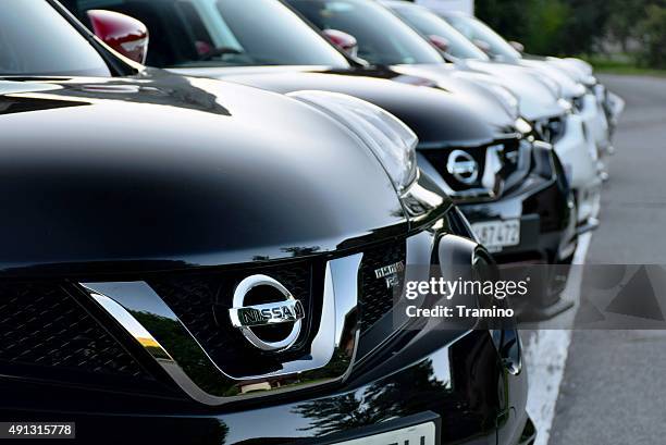 nissan cars in a row - nissan stock pictures, royalty-free photos & images