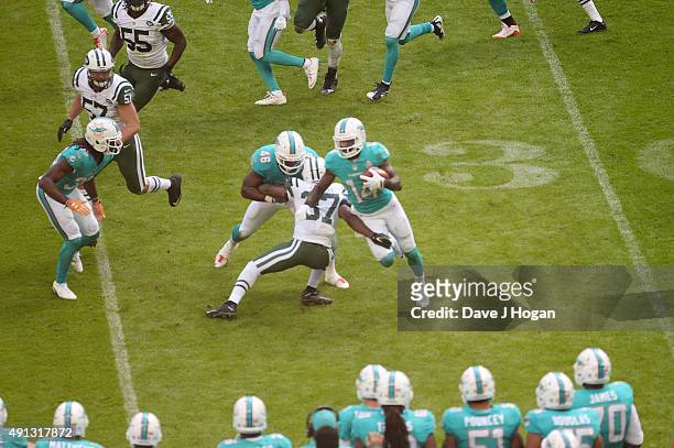 Neville Hewitt protects Jarvis Landry against Jaiquawn Jarrett during the annual NFL International Series as the New York Jets compete against the...