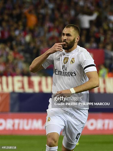 Real Madrid's French forward Karim Benzema celebrates after scoring during the Spanish league football match Club Atletico de Madrid vs Real Madrid...