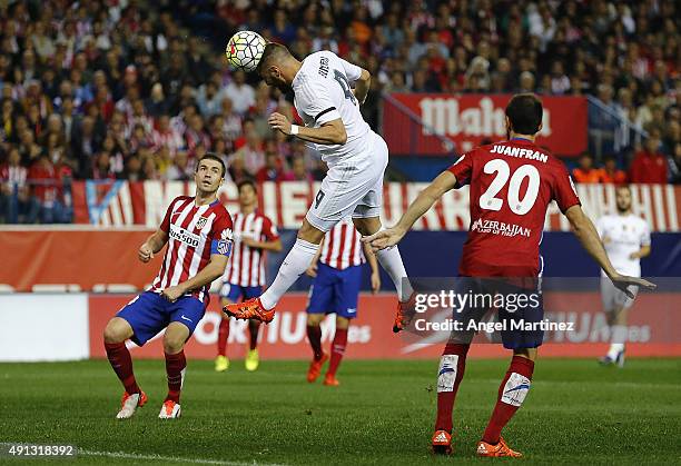 Karim Benzema of Real Madrid heads the ball to score the opening goal during the La Liga match between Club Atletico de Madrid and Real Madrid CF at...